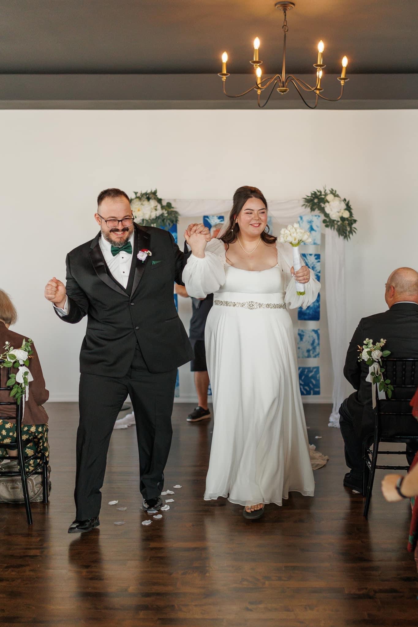 Joyful couple recessional at Haley Station wedding venue, Escanaba Michigan